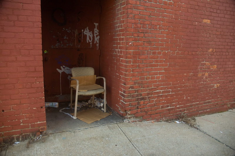 A chair in a building alcove.