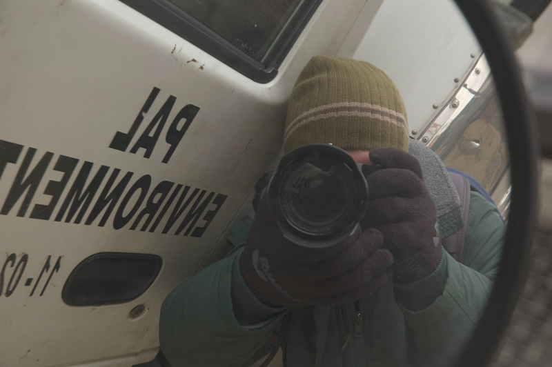 A photographer taking his own picture in a mirror.