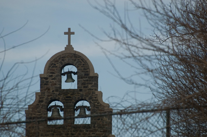 Bells in a facade evoke a Spanish Mission.