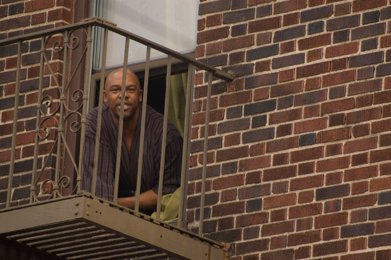 A man poking his head out his window.