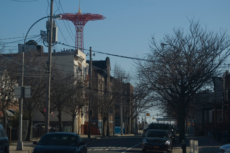 The tower of an old amusement park ride rises high over a neighborhood.