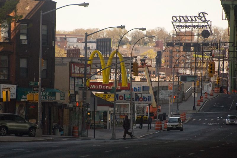A series of city blocks, with businesses and signs.