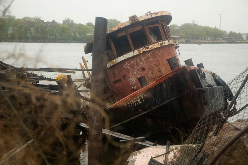 An abandoned tugboat tilting to one side