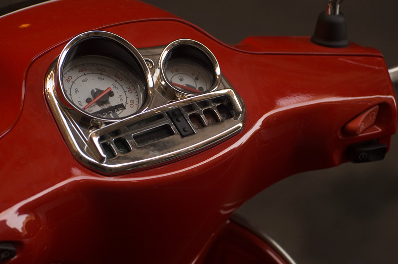 Dials of a red motor scooter dashboard