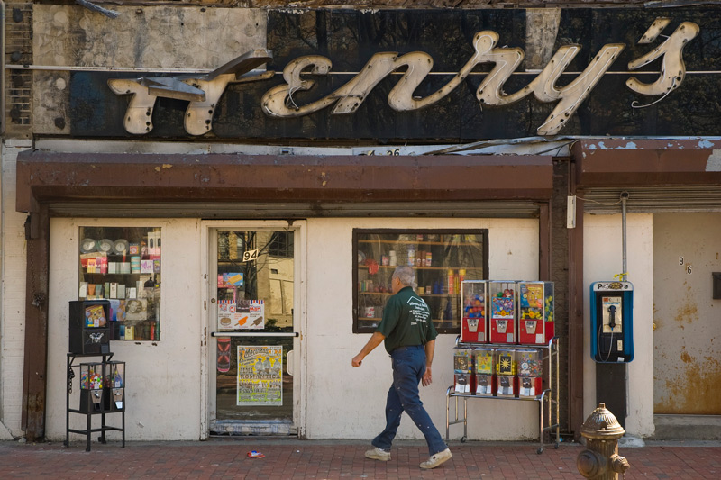 A small convenience store with an old neon sign