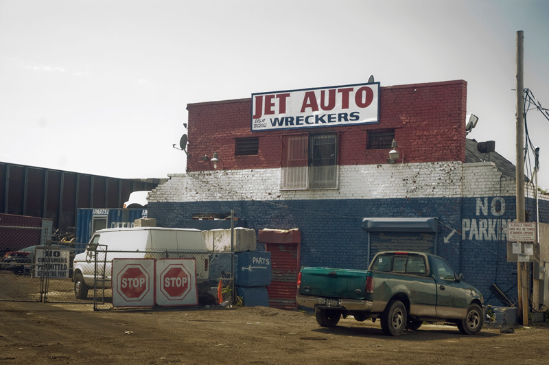 An old brick building, painted red, white and blue