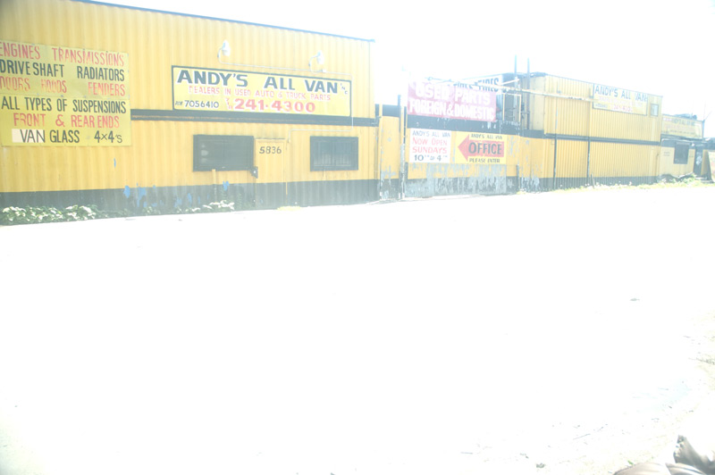 An auto junk yard, surrounded in white