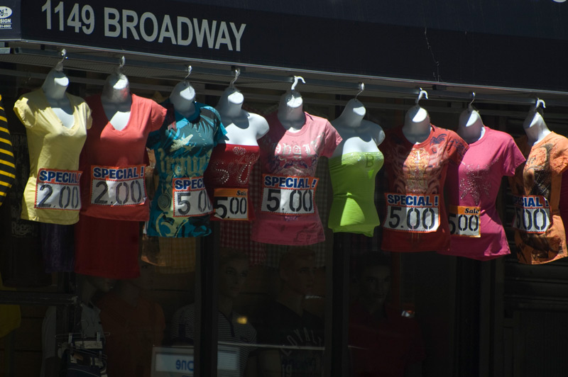 A variety of colorful women's tops hanging on display