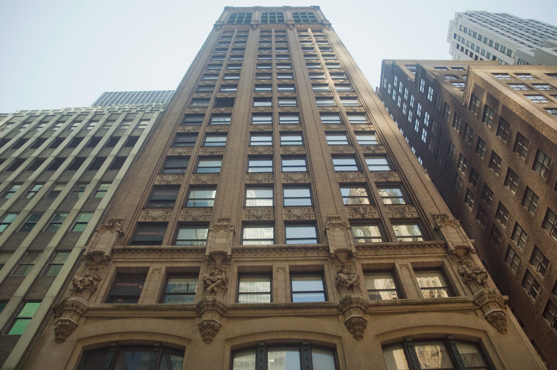 A building with carved figures ascends to the sky