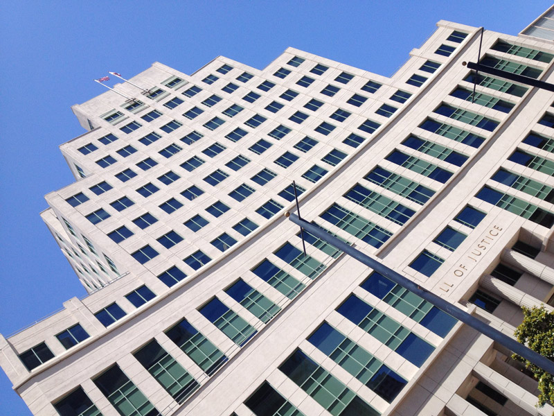 A tall government building against a blue sky.