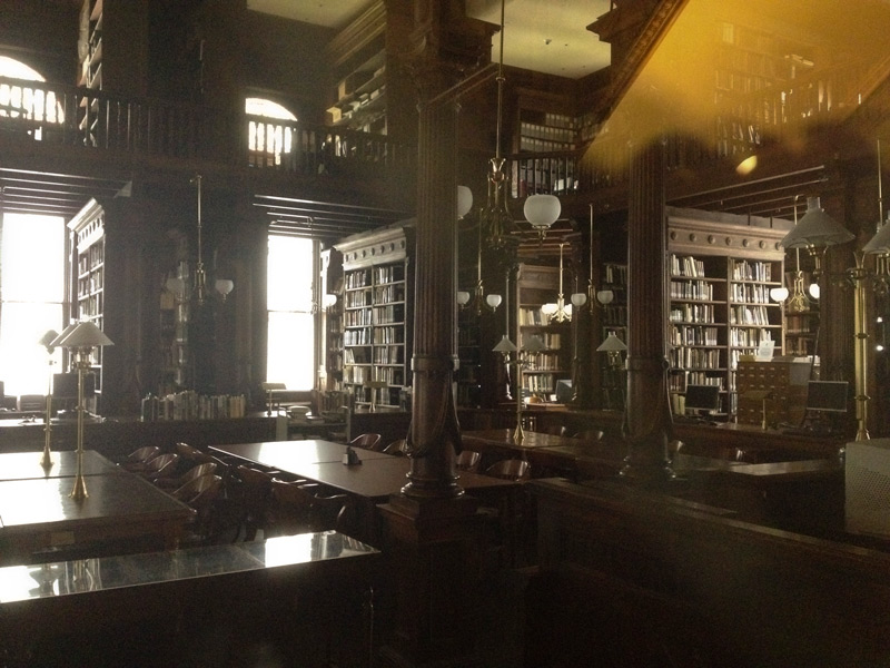 A room full of bookshelves and tables.