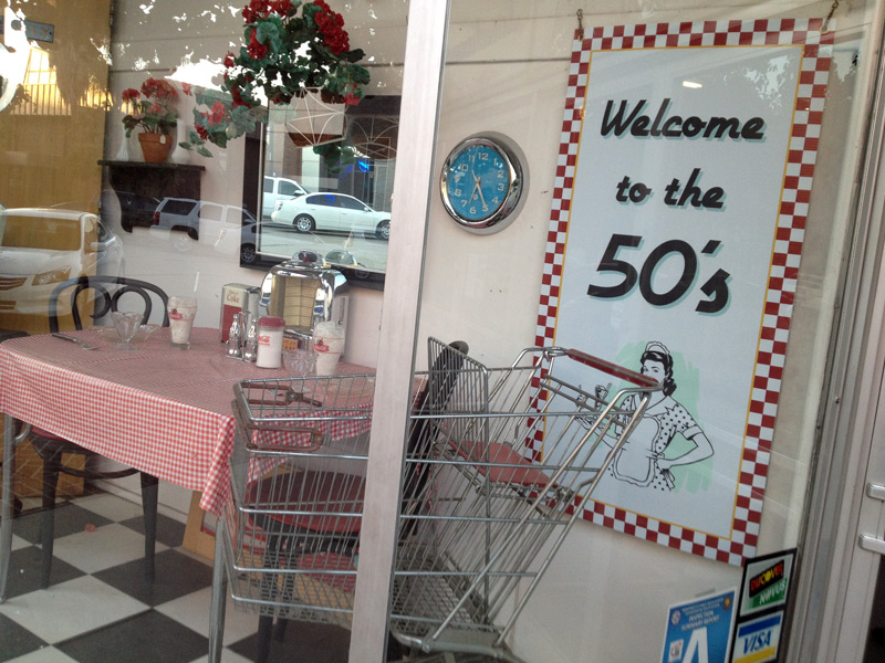 A store window decorated in a 1950's style.