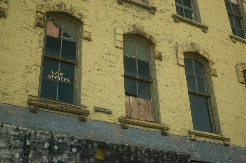 Gold leaf lettering of a law firm, in an abandoned bubilding.