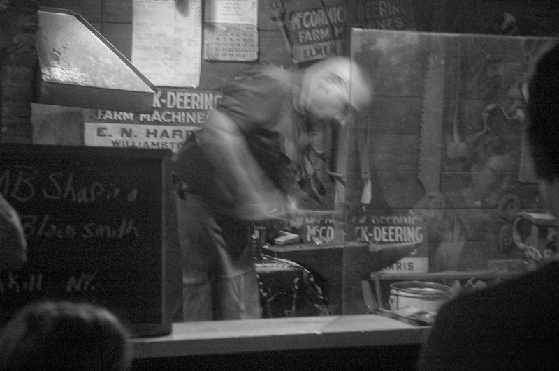 A blacksmith, working at an anvil.