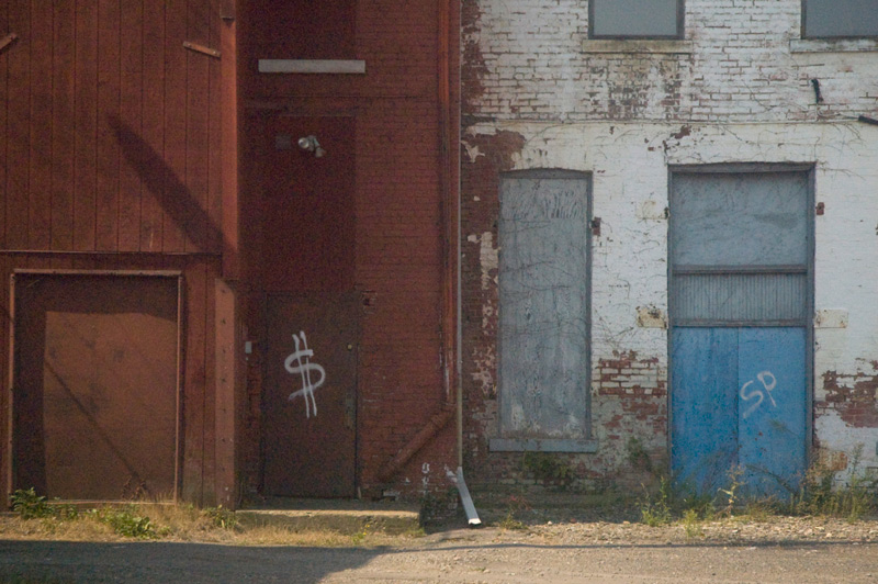 Back doors of empty industrial buildings.