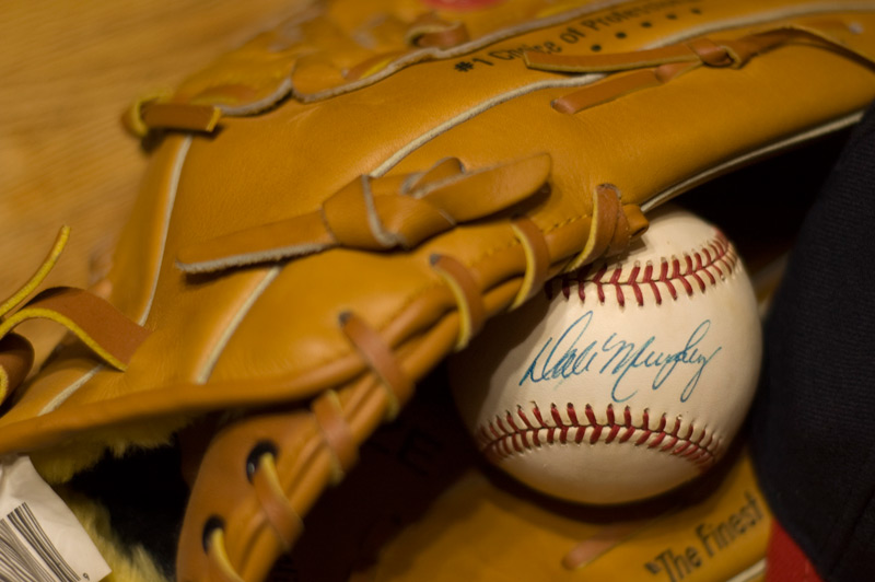A signed baseball, and a baseball glove.