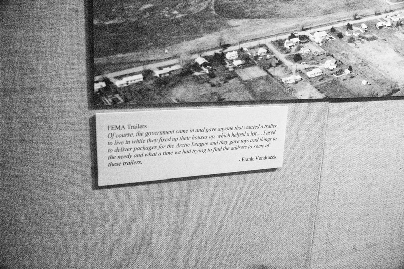 An aerial photo of flood damage, and a card describing FEMA trailers.