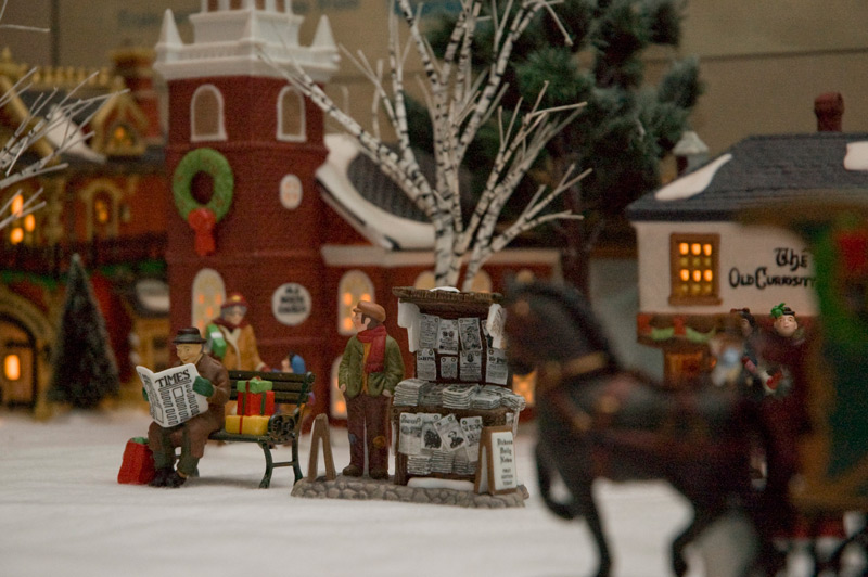 Winter figurines, with one reading a newspaper