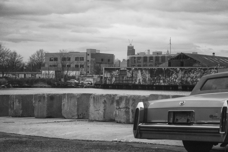 A Cadillac parked in an industrial area.