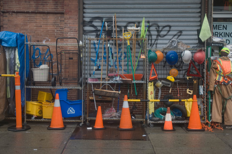 Racks of street cones, brooms, mops.