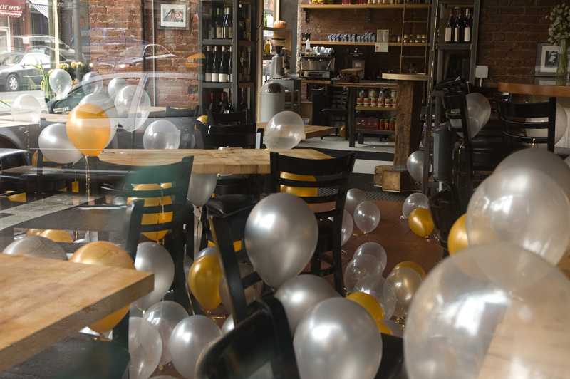 Helium party balloons laying on floor and tables