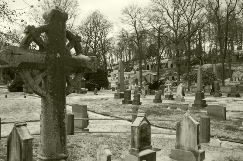 A cross and tombstones under snow