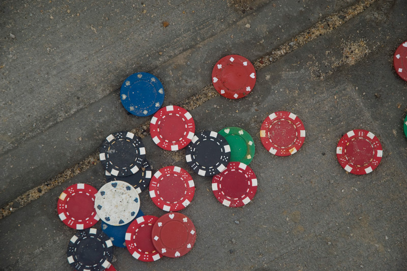 Ornamented poker chips on a sidewalk.