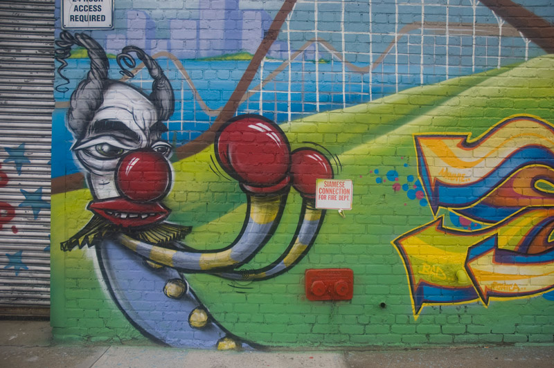 A mural, of clown in boxing gloves and fighter stance.