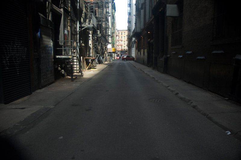 A narrow alley between rows of buildings.