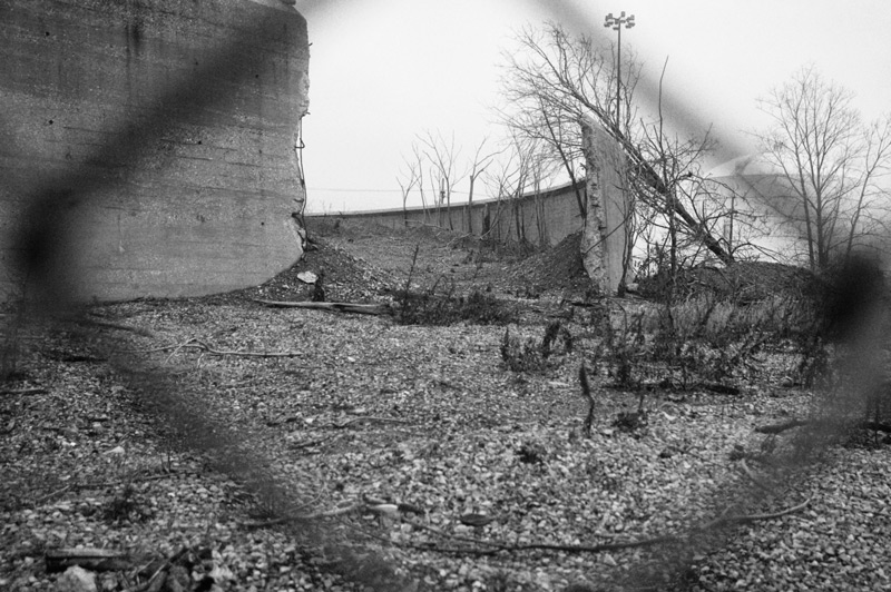 Circular concrete tanks in an industrial wasteland