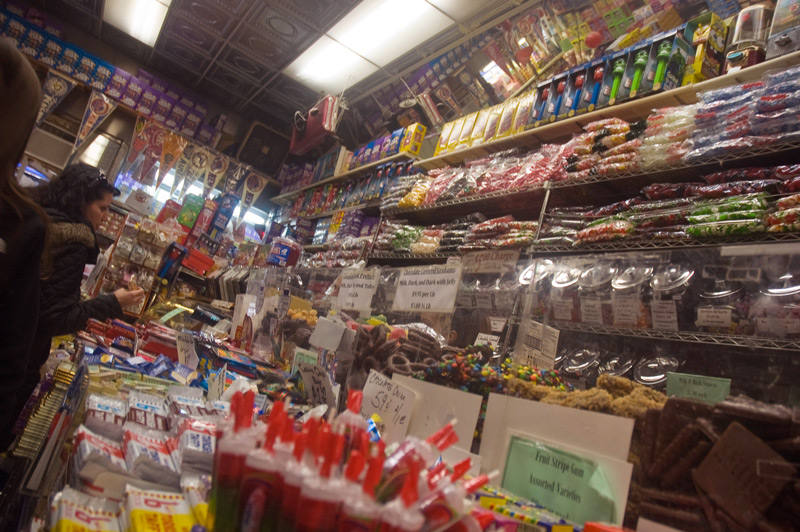 A customer examines in a candy store packed with candy