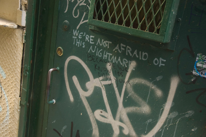A green door with graffiti