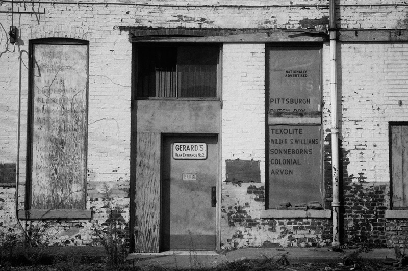 Old building for a paint store, with boarded up windows