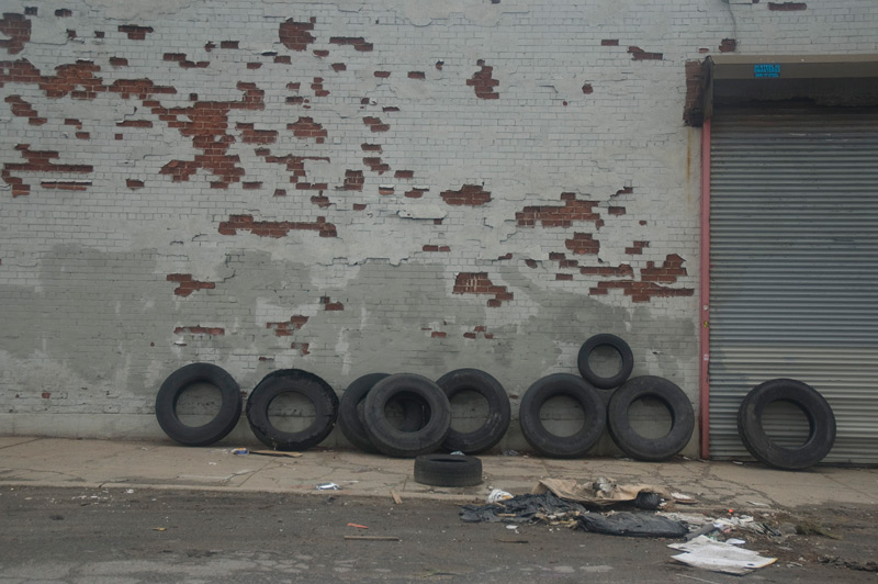 Tires lined up against a wall