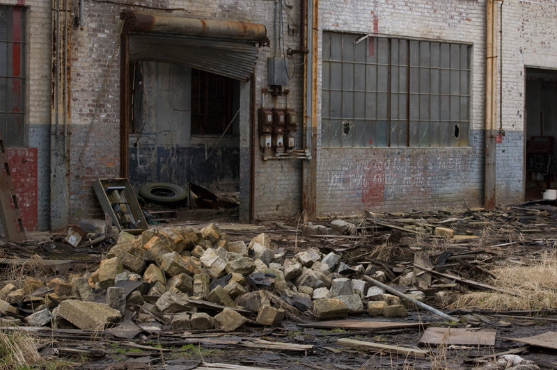 A large empty room with debris