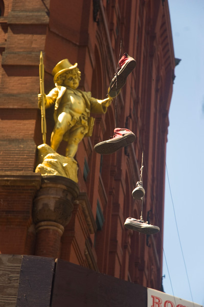 Sneakers hanging from overhead wires