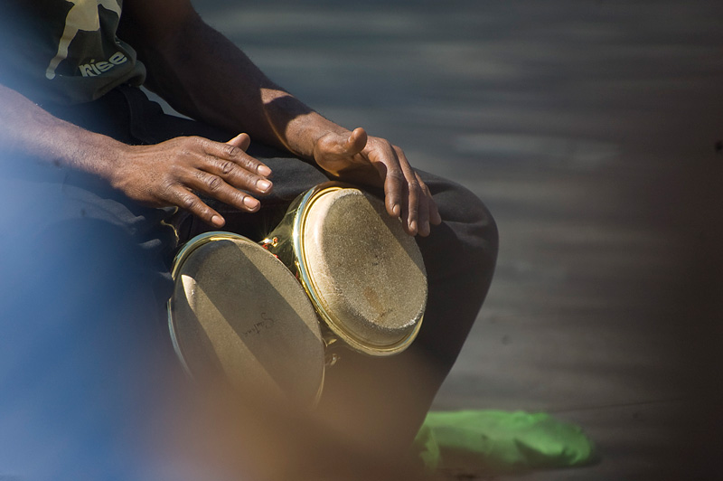 Two hands over a bongo drum