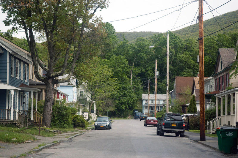 Cars, houses, trees, and a mountain