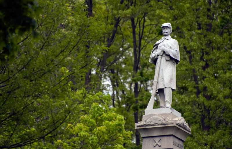 A statue of a Union soldier, among trees