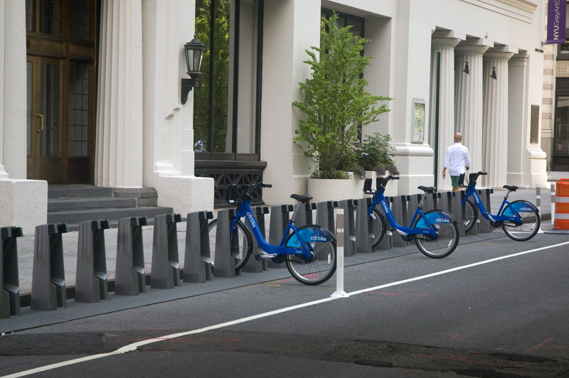 A mostly empty rack of bike share bikes