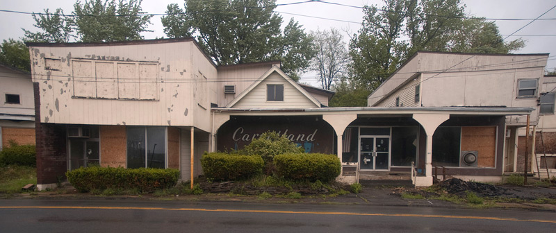 A large storefront in disrepair