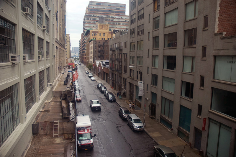 An industrial street with parked cars.