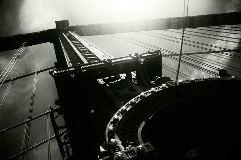 Looking up at a tower of the Manhattan Bridge.