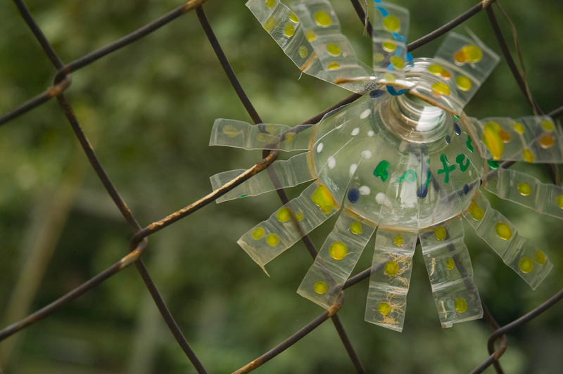 A plastic bottle, cut and splayed as a flower.