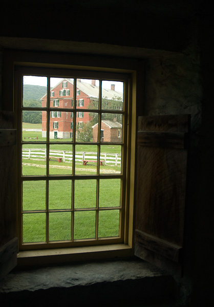 A brick building, seen through a window.