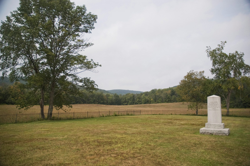 An obelisk in an empty field.