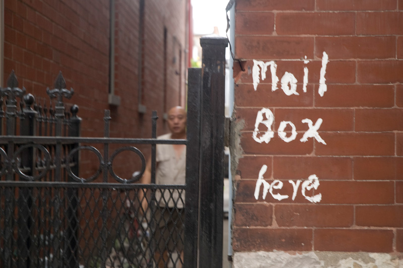 A hand painted message pointing out the mail box.