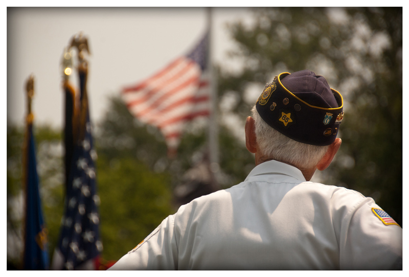 A veteran looks at the United States flag.
