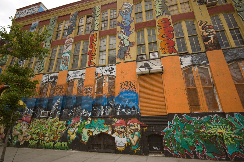 A building, covered in brilliant colors and graffiti.