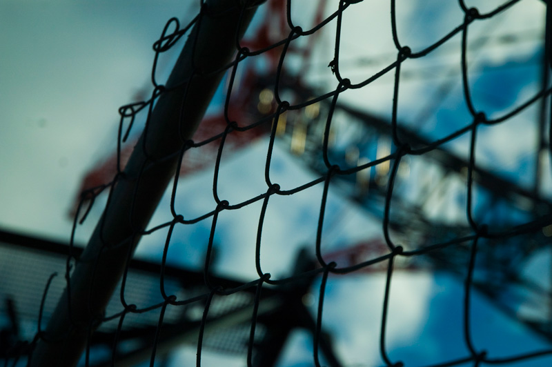 Chain link fence and a crane.